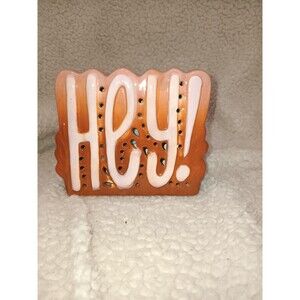 Brown/pink ceramic HEY sign